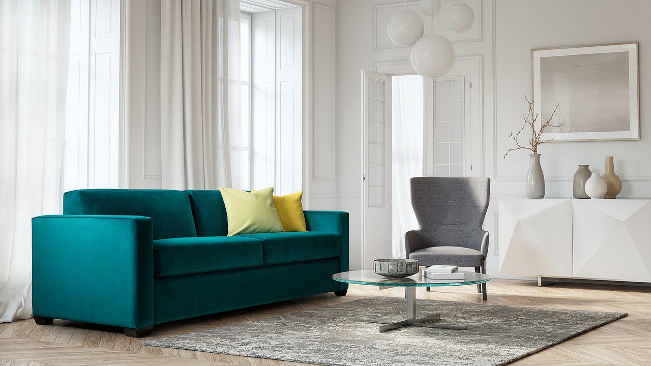green sofa bed with coffee table and chair